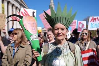 A woman dressed as the Statue of Liberty protests against US president Donald Trump